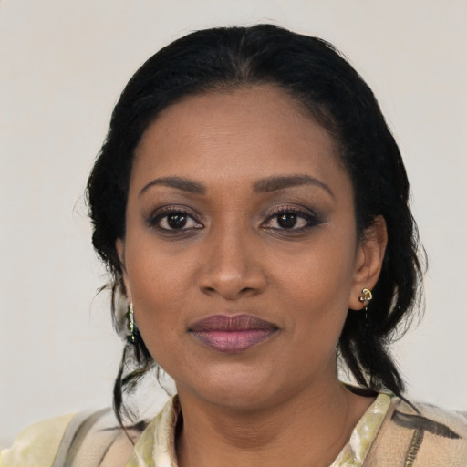 Joyful black young-adult female with medium  black hair and brown eyes