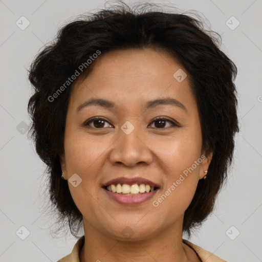 Joyful latino adult female with medium  brown hair and brown eyes