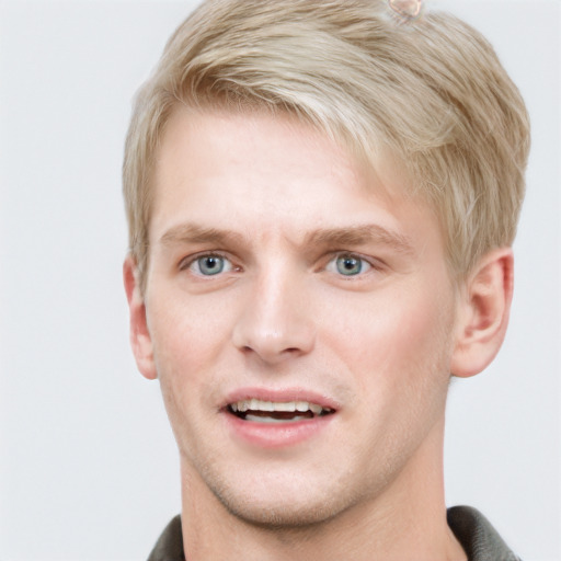 Joyful white young-adult male with short  brown hair and blue eyes