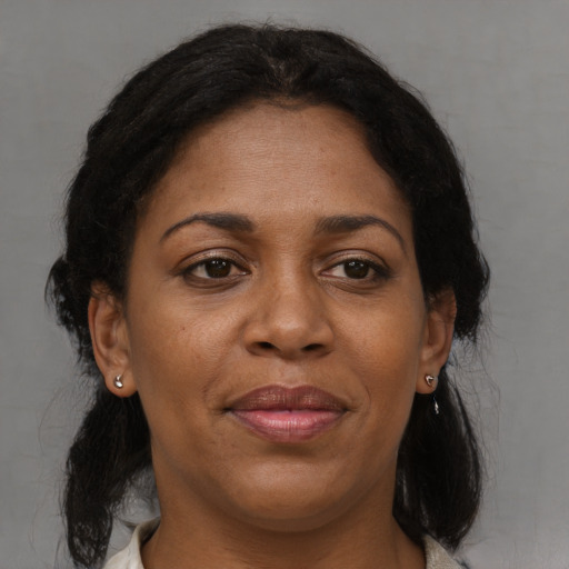 Joyful black adult female with medium  brown hair and brown eyes