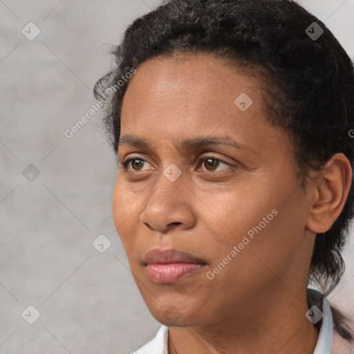 Joyful black adult female with short  black hair and brown eyes