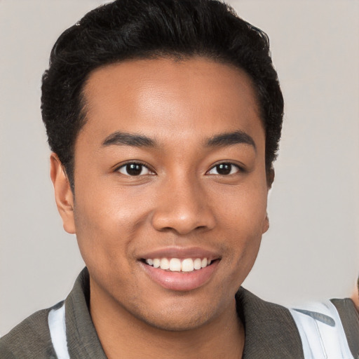 Joyful white young-adult male with short  black hair and brown eyes