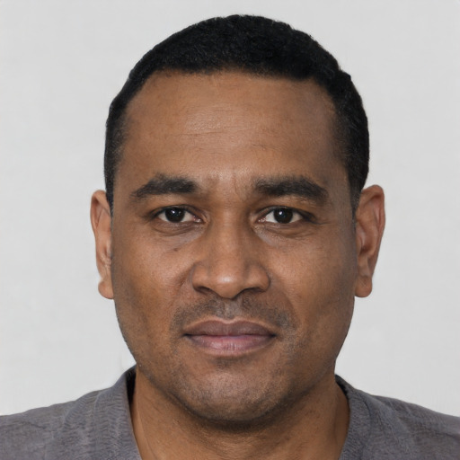 Neutral latino adult male with short  black hair and brown eyes