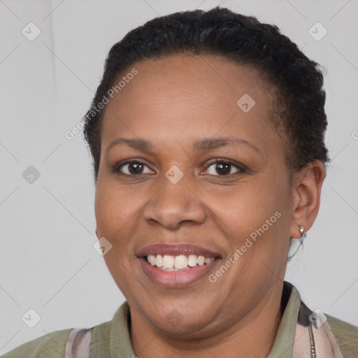 Joyful black young-adult female with short  brown hair and brown eyes