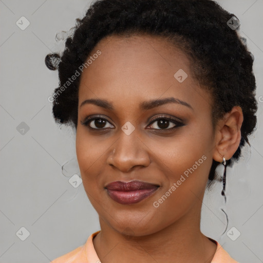 Joyful black young-adult female with medium  brown hair and brown eyes