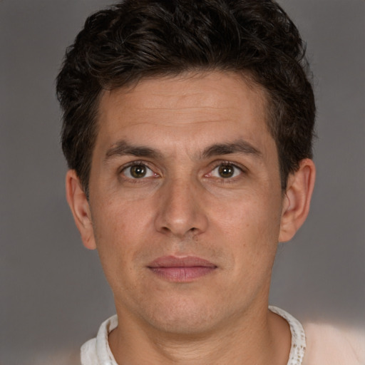 Joyful white adult male with short  brown hair and brown eyes