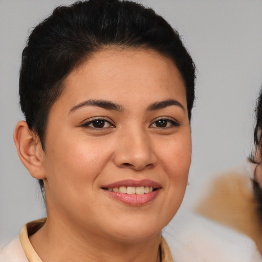 Joyful latino young-adult female with short  brown hair and brown eyes