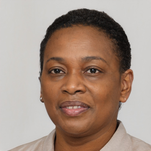 Joyful black adult female with short  black hair and brown eyes