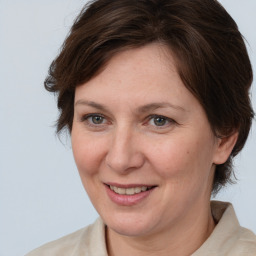 Joyful white adult female with medium  brown hair and brown eyes