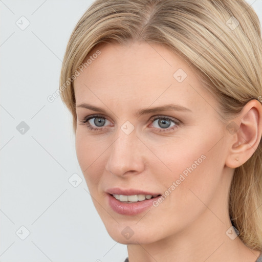 Joyful white young-adult female with long  brown hair and blue eyes