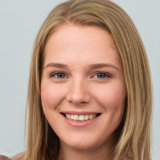 Joyful white young-adult female with long  brown hair and blue eyes