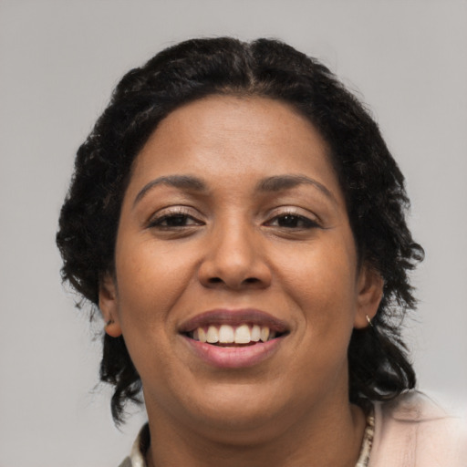 Joyful latino young-adult female with medium  black hair and brown eyes