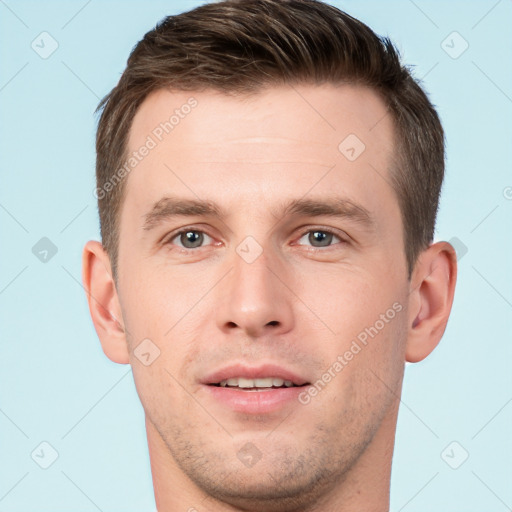 Joyful white young-adult male with short  brown hair and grey eyes