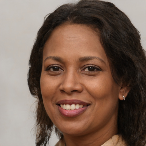 Joyful latino adult female with medium  brown hair and brown eyes