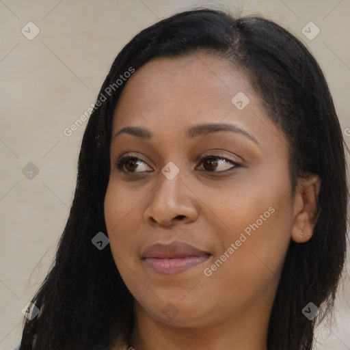 Joyful black young-adult female with long  black hair and brown eyes