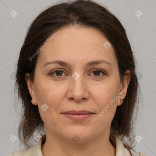 Joyful white adult female with medium  brown hair and brown eyes