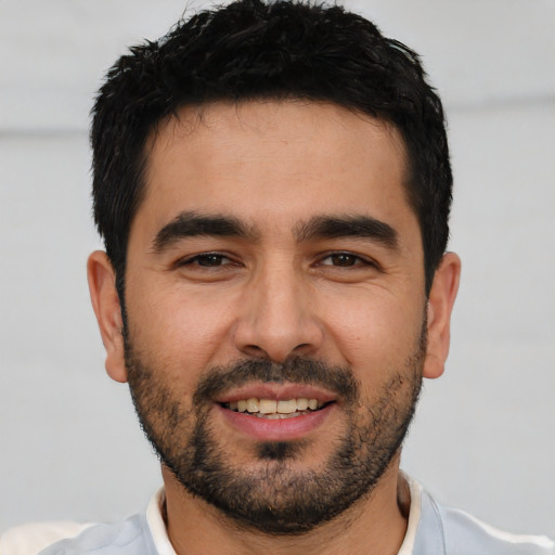 Joyful white young-adult male with short  black hair and brown eyes