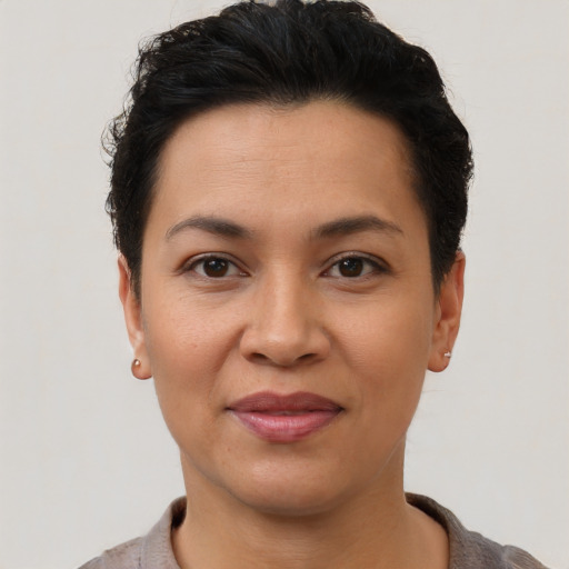 Joyful latino young-adult female with short  black hair and brown eyes