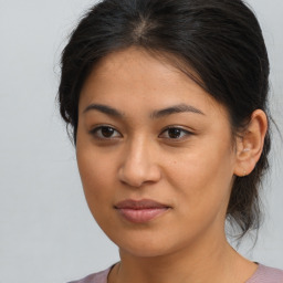 Joyful latino young-adult female with medium  brown hair and brown eyes