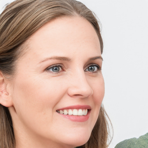 Joyful white young-adult female with medium  brown hair and green eyes