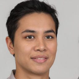 Joyful asian young-adult male with short  brown hair and brown eyes