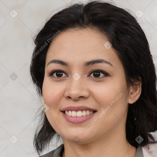 Joyful latino young-adult female with medium  brown hair and brown eyes