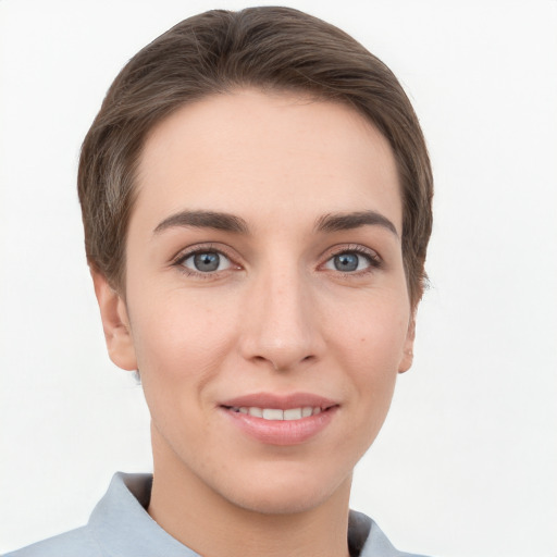 Joyful white young-adult female with short  brown hair and grey eyes