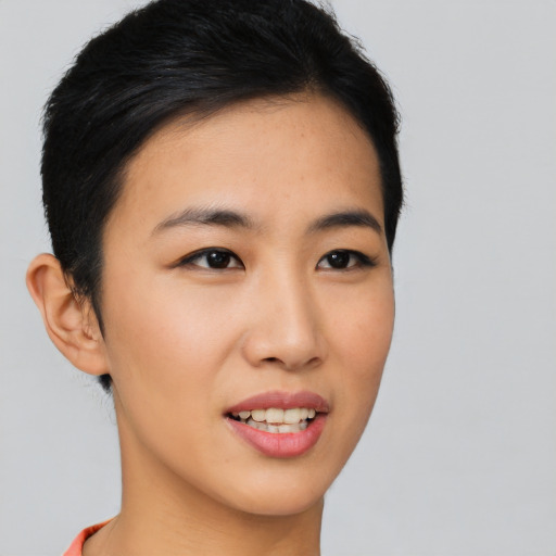 Joyful asian young-adult female with short  brown hair and brown eyes