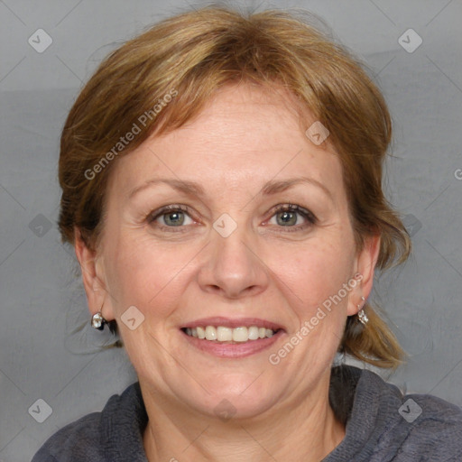 Joyful white adult female with medium  brown hair and blue eyes