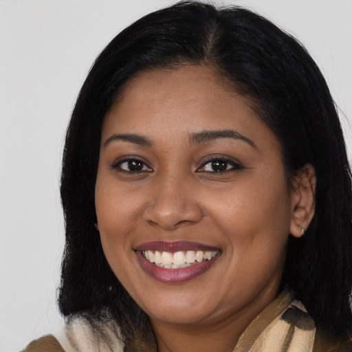 Joyful latino young-adult female with medium  black hair and brown eyes