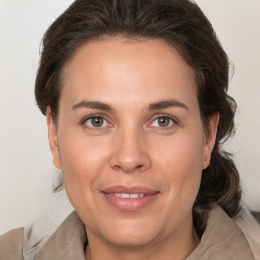 Joyful white adult female with medium  brown hair and grey eyes