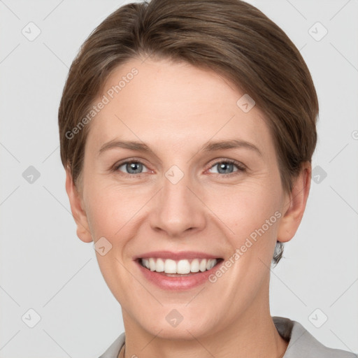 Joyful white young-adult female with short  brown hair and grey eyes