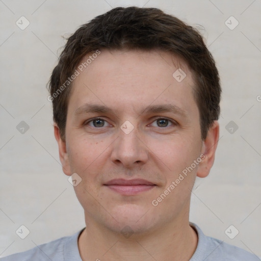 Joyful white young-adult male with short  brown hair and grey eyes