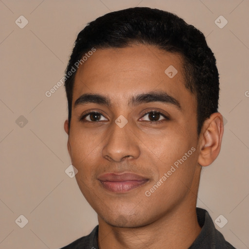 Joyful latino young-adult male with short  black hair and brown eyes