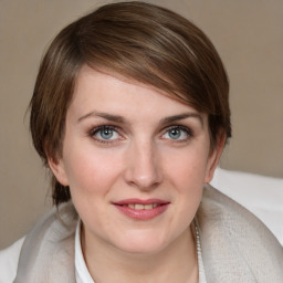 Joyful white young-adult female with medium  brown hair and grey eyes