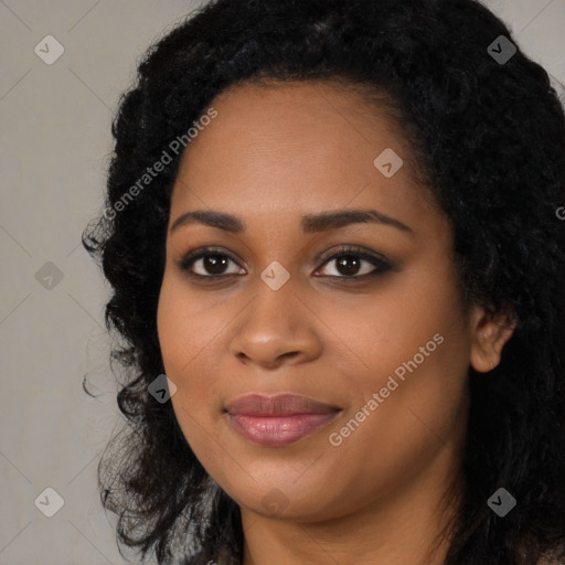 Joyful black young-adult female with long  black hair and brown eyes