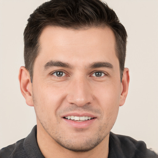 Joyful white young-adult male with short  brown hair and brown eyes