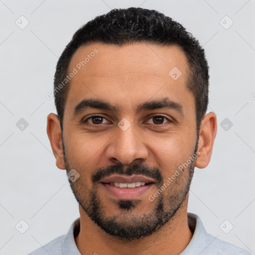 Joyful latino young-adult male with short  black hair and brown eyes