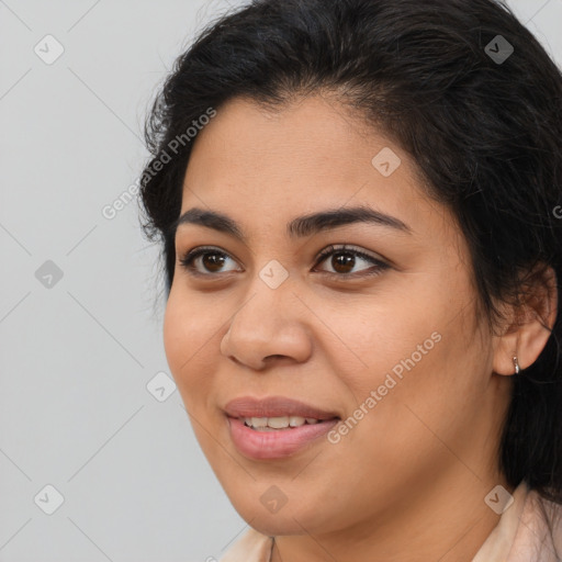 Joyful latino young-adult female with medium  brown hair and brown eyes