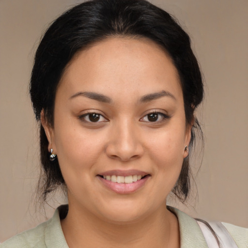 Joyful latino young-adult female with medium  brown hair and brown eyes