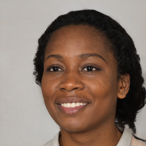 Joyful black young-adult female with medium  black hair and brown eyes