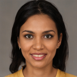 Joyful black young-adult female with medium  brown hair and brown eyes