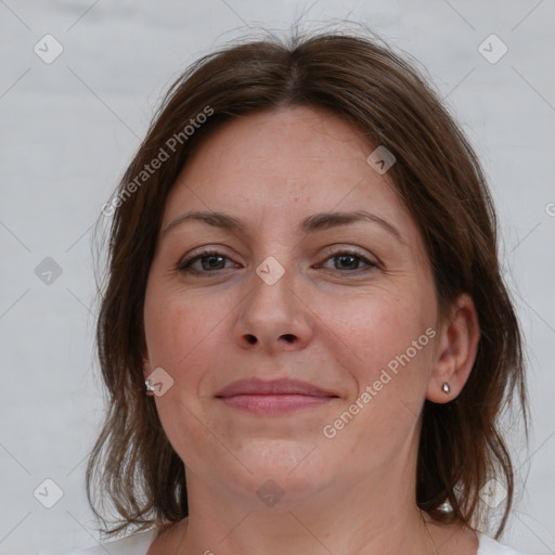 Joyful white adult female with medium  brown hair and brown eyes