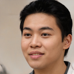 Joyful asian young-adult male with short  black hair and brown eyes