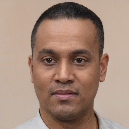 Neutral latino adult male with short  black hair and brown eyes