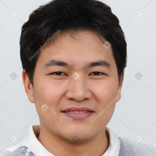 Joyful asian young-adult male with short  brown hair and brown eyes