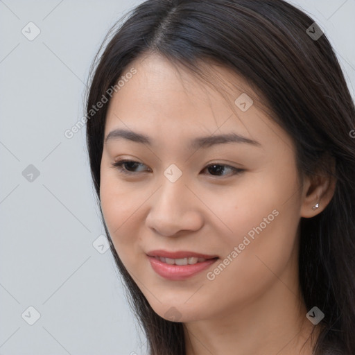 Joyful asian young-adult female with long  brown hair and brown eyes