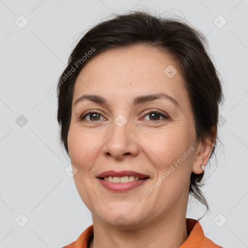 Joyful white adult female with medium  brown hair and brown eyes