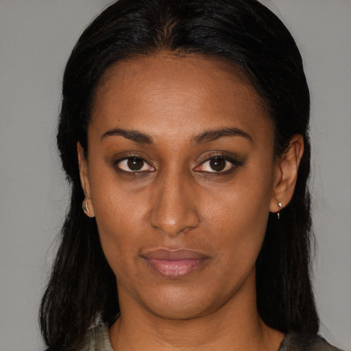 Joyful black young-adult female with medium  brown hair and brown eyes