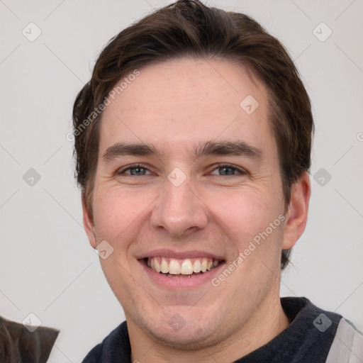 Joyful white adult male with short  brown hair and grey eyes